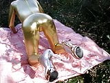 Golden tight jumpsuit and golden heels, stand on all fours